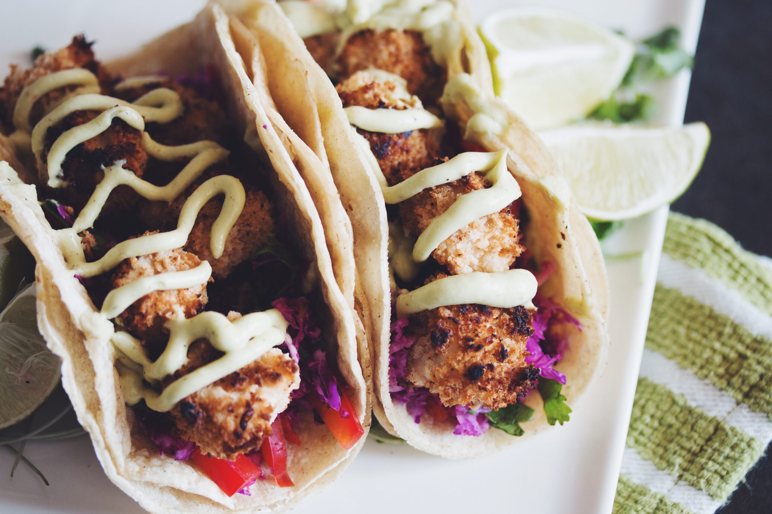 a plate of two crispy coconut tofu tacos