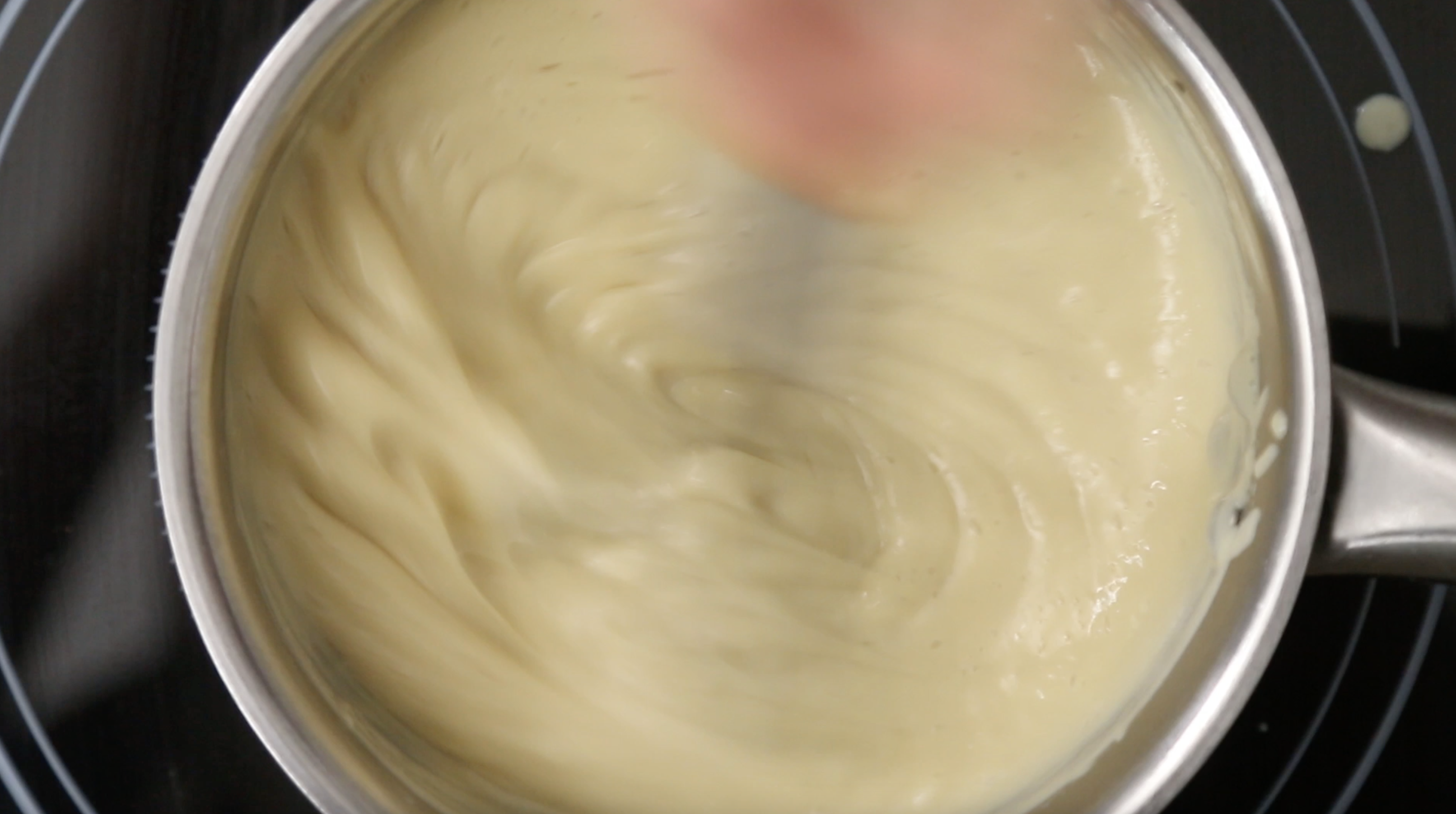 saucepan heatin the custard and stirring with whisk