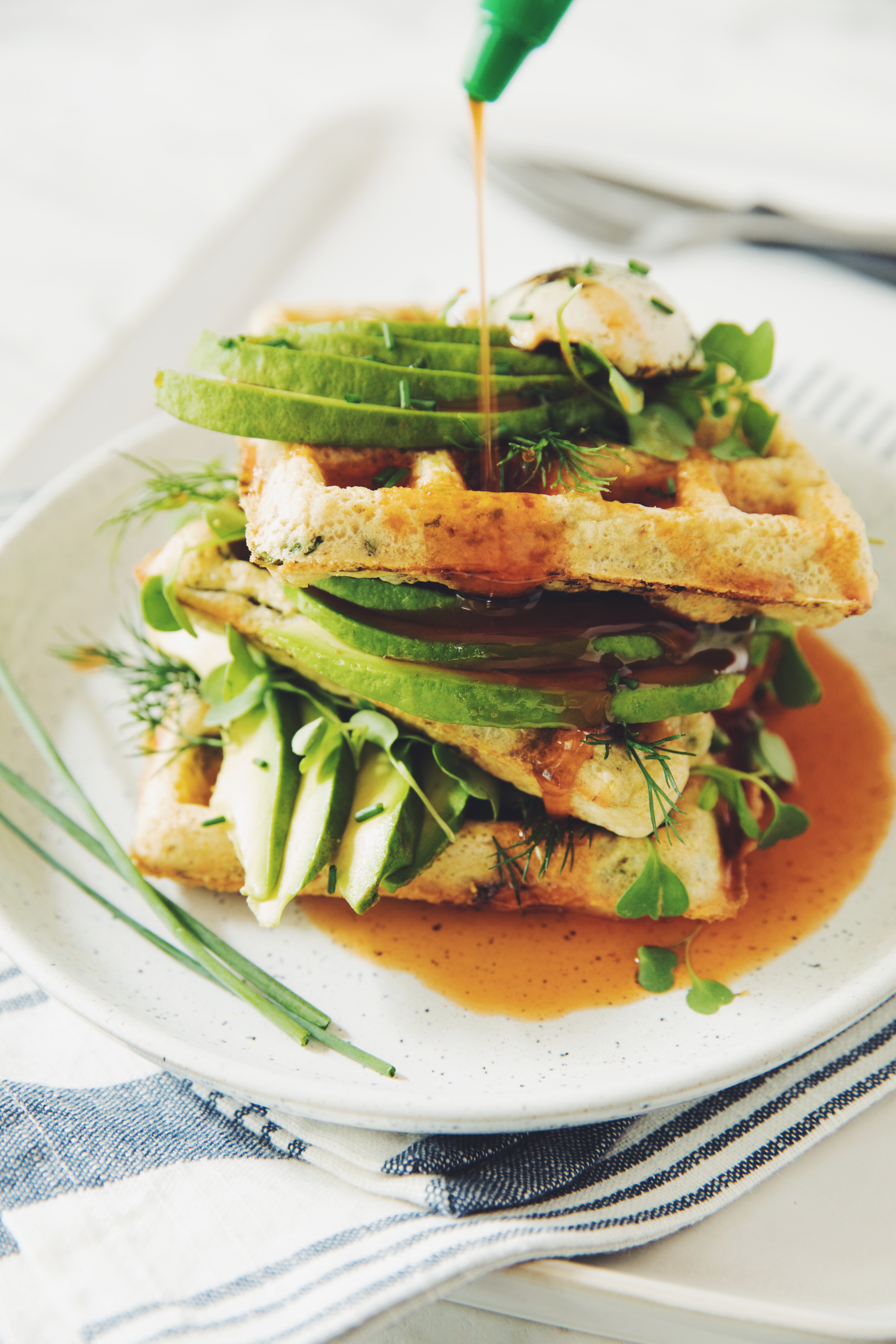 green waffles with spinach, avocado and sriracha maple syrup vegan recipe