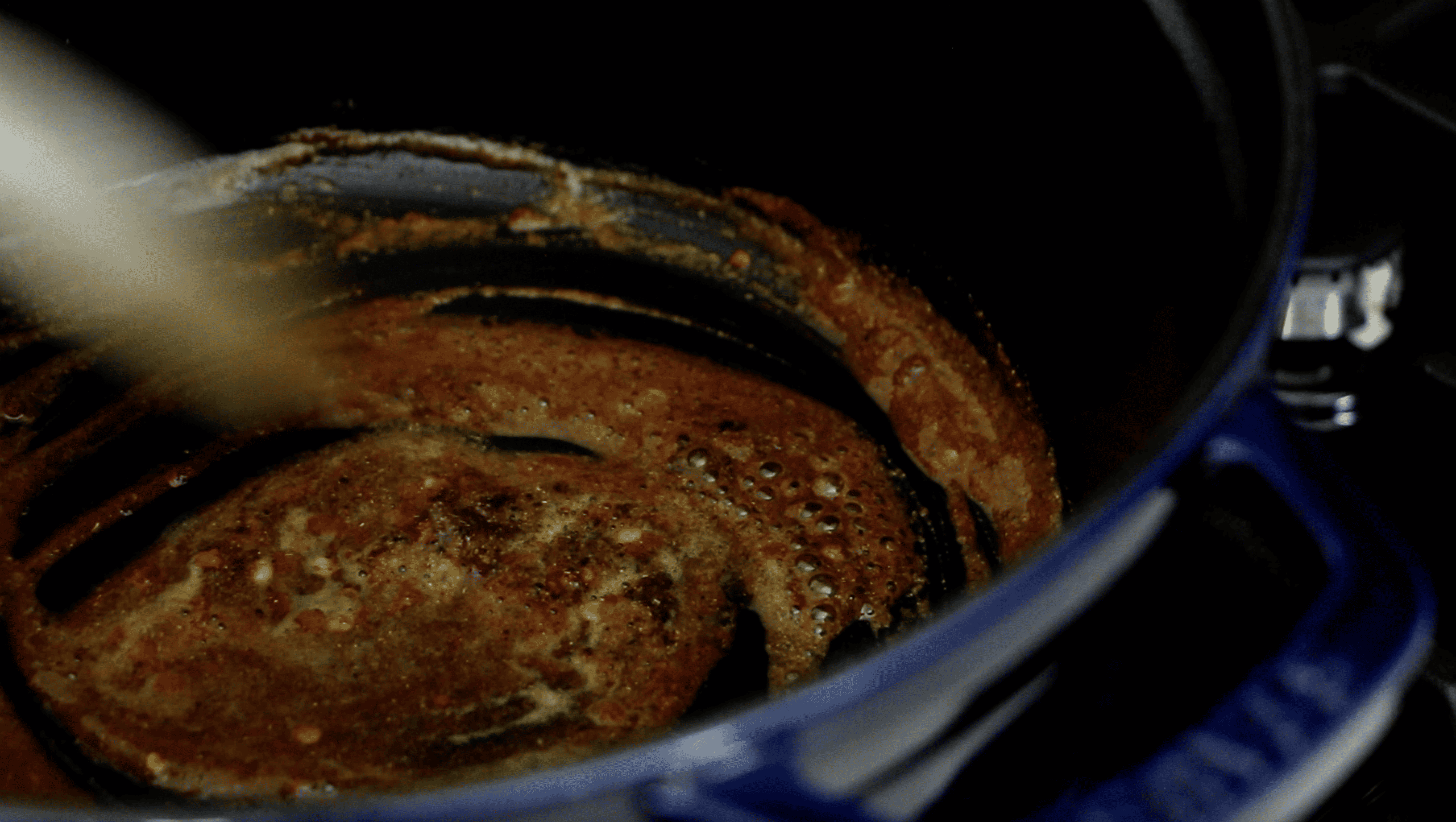 a pot with spices and oil being cooked