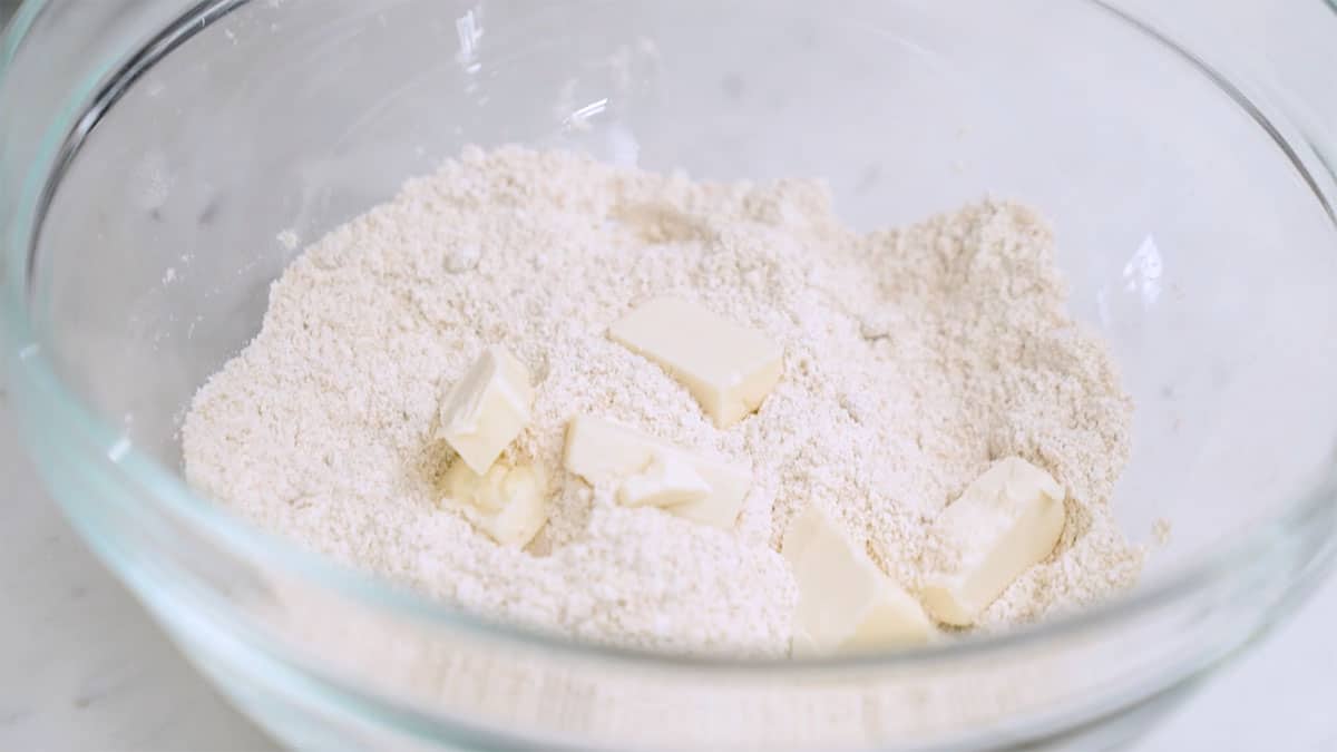 mixing bowl with flour and cubed vegan butter in it