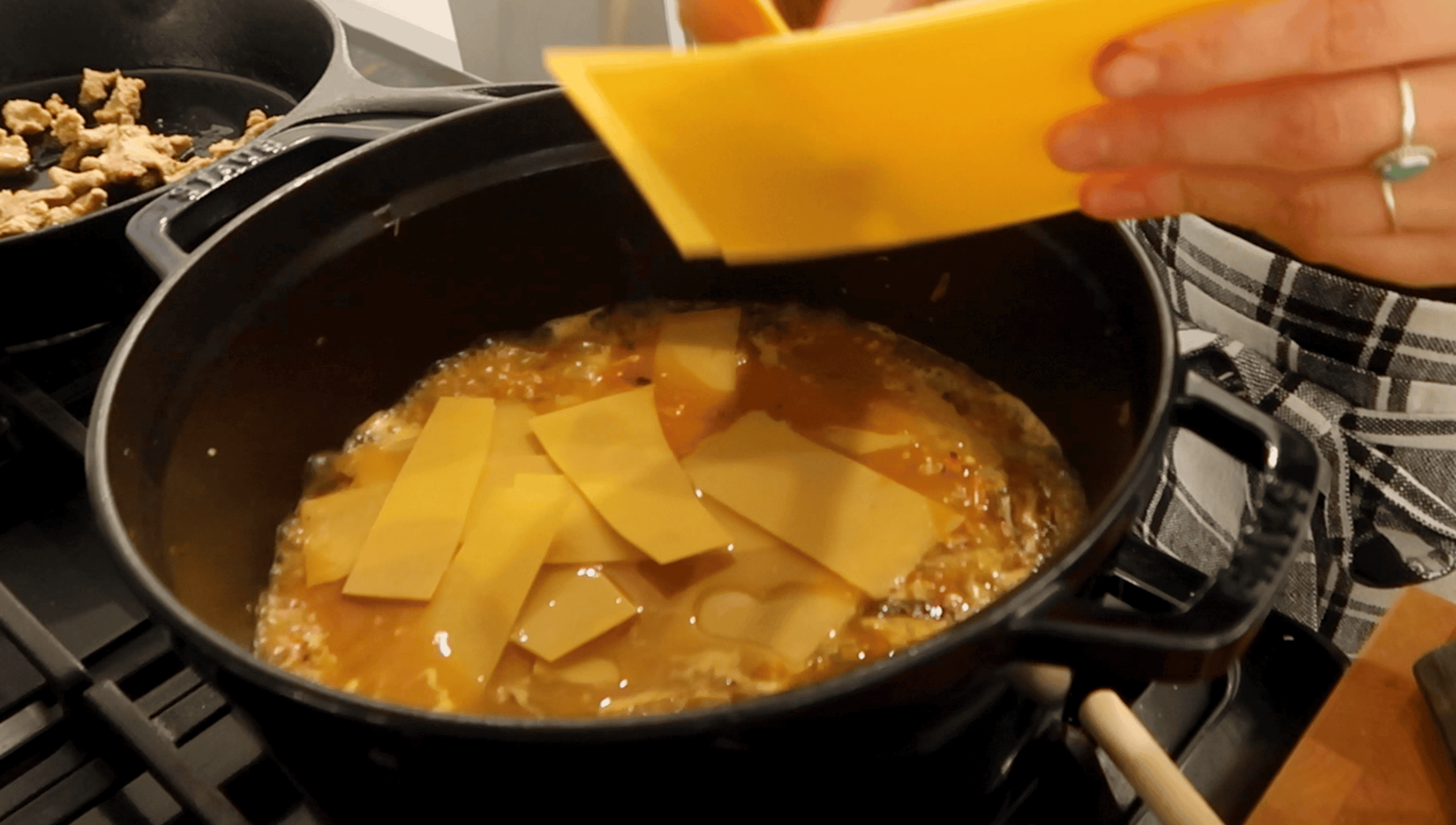 lasagna being broken into a pot of soup