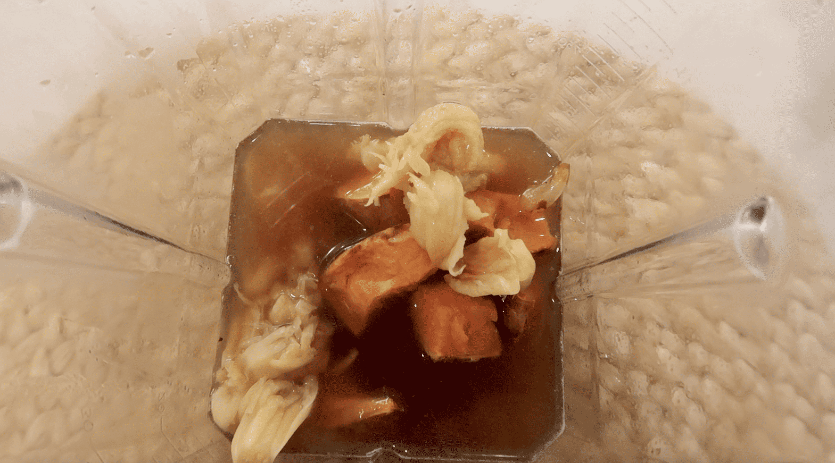 blender with broth, garlic and sweet potato