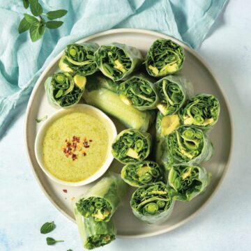 overhead of all green fresh rolls cut in half facing up to show fillings