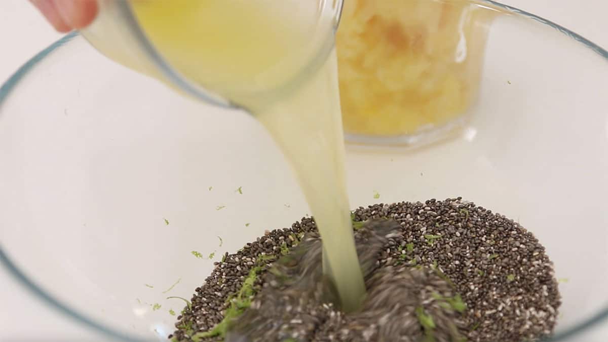 mixing bowl with chia seeds and lime juice being poured over top